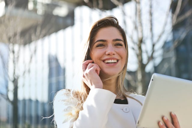 someone on a phone call holding a tablet